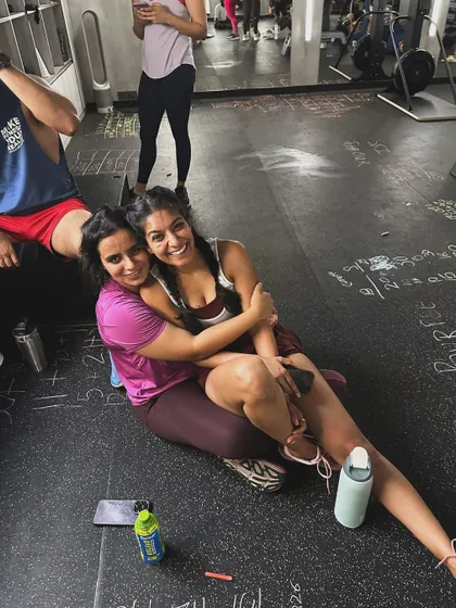 The aftermath of a tough workout. Two members share a hug on the gym floor, surrounded by chalk marks from the session. This is what support and friendship look like at Knox.