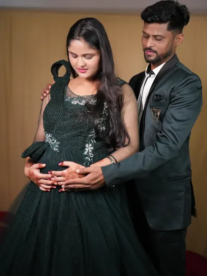 A beautiful couple's shot with the dad-to-be cradling the baby bump. These are memories to cherish forever.
