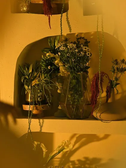 A beautifully lit floral arrangement within one of the wall niches. The play of light and shadow adds depth and a touch of mystery to the decor.