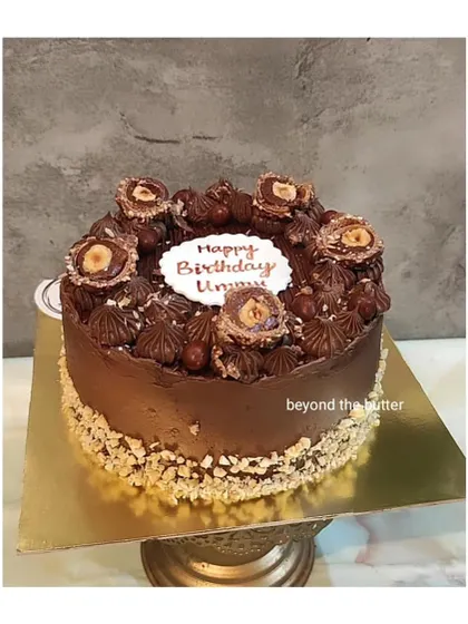 A rich chocolate hazelnut cake with a crunchy almond border, perfect for a birthday celebration.