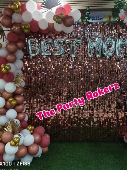 Another view of the Mother's Day backdrop, showing the beautiful combination of the shimmer wall, balloons, and artificial flowers.