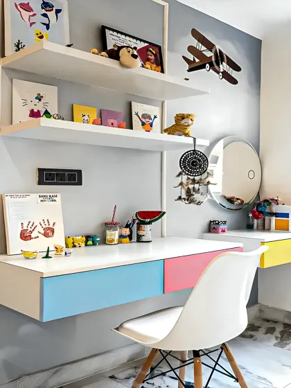 We created this bright and cheerful study corner for a child's room. The floating desk features colorful drawers in blue, pink, and yellow, with open wall shelves above for displaying books, art, and toys.