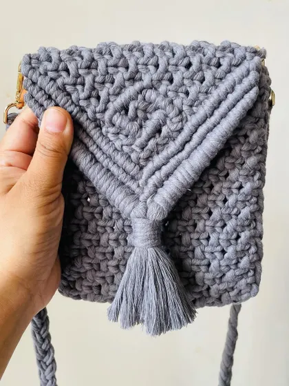 This grey mobile sling bag is so practical and stylish. The V-flap design has a cute tassel, and it's just the right size to carry your phone and cards.