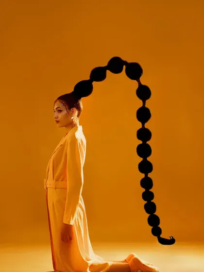 A high-fashion editorial I conceptualized called "The Yellow Fever." This look features a dramatic, sculptural bubble ponytail and a yellow trench coat, creating a unique and artistic fashion statement.