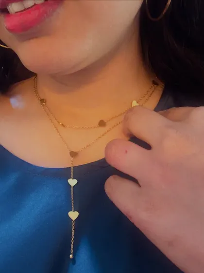 A detailed look at a layered heart necklace from Palmonas, demonstrating how it sits beautifully and adds a touch of romance to any outfit.