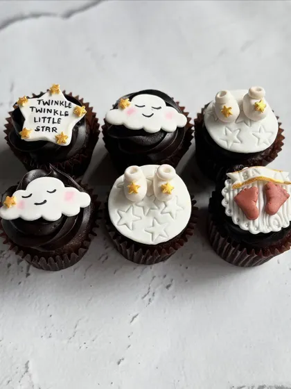 Welcoming a little one with these sweet "Twinkle Twinkle Little Star" themed cupcakes. I hand-sculpted each fondant topper, including the smiling clouds, tiny baby booties, and starry messages.