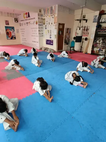 A seated forward bend stretch, another key exercise for flexibility.