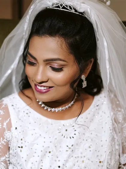 A close-up of my Christian bride's makeup. I used soft, shimmery eyeshadow and a berry-toned lip to enhance her features while maintaining a classic and elegant feel.