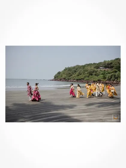 A unique shot of the wedding party walking along the beach in Goa.