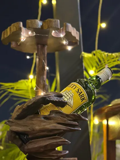 Beauty is in the details. This unique, rustic wooden bottle holder is both a functional piece and a work of art, adding a touch of natural elegance to the bar setup.