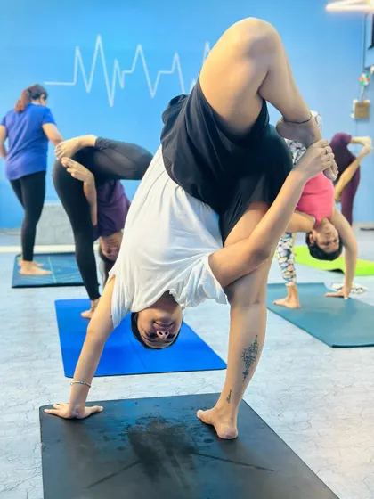 Another student in a standing split variation, showing great balance and flexibility.