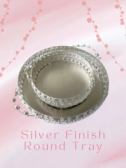 This silver-finish round tray is a versatile piece for any celebration. Its detailed filigree work makes it an elegant base for serving drinks, presenting gifts, or creating a hamper.