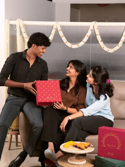 Friends and colleagues sharing a happy moment over our festive hampers. Our gifts are designed to be at the center of your celebrations, making every interaction special.