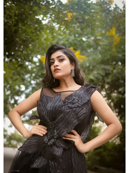 This close-up highlights the detailed craftsmanship of the black gown's bodice, making it a true statement piece for any special occasion.