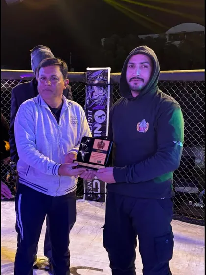 Our coach receiving an honor from the One Impact organization at the Elite Combat event in Ajmer.