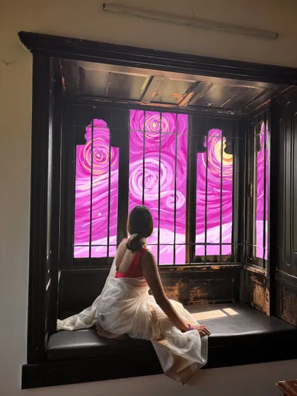 I turned this window into a piece of art by drawing a vibrant, swirling pink sky inspired by Van Gogh's Starry Night.