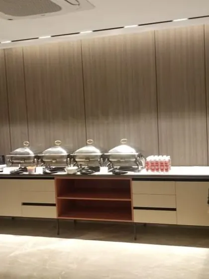A sleek, in-house buffet setup for a birthday party, integrated seamlessly with the venue's own counters for a polished look.