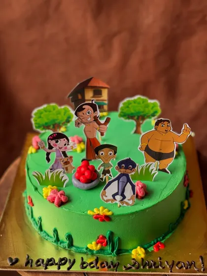 A Chota Bheem themed cake, bringing the popular Indian cartoon to life. The vibrant green buttercream sets the scene for Bheem and his friends.