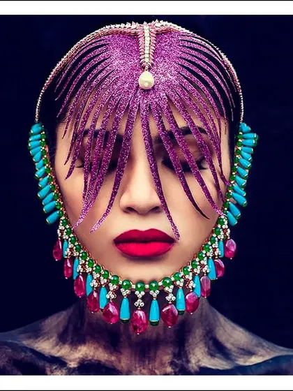 An exploration of conventional beauty, using an ornate, face-framing headpiece and bold makeup. The image challenges traditional portraiture by using accessories to create a mask-like effect.