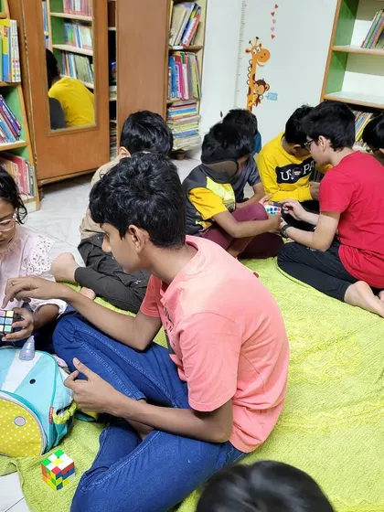 Our library floor is covered with kids deep in concentration during our Rubik's cube meetup. This is peer-to-peer learning at its best, fostering patience and logical thinking.