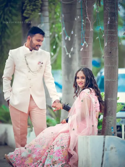 A lovely moment between the bride and groom at their reception. Her soft pink lehenga was paired with a romantic makeup look and gentle curls for a fairy-tale feel.