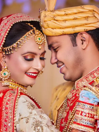 This close-up shot is all about the couple's joyful connection. The bride's bright red lipstick and the groom's smile create a vibrant and happy portrait.