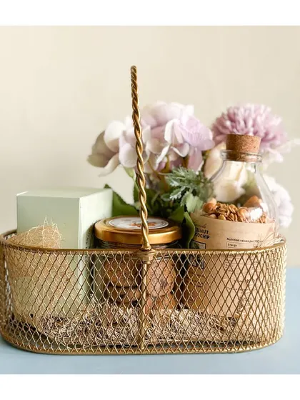 Another look at our elegant golden basket hamper, perfect for making your Rakhi celebrations extra special. It's filled with a variety of our most-loved treats.