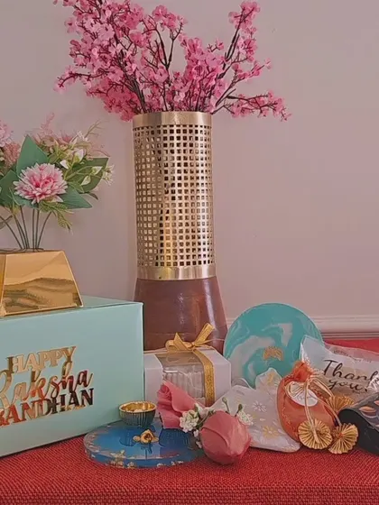 Announcing my limited-edition Rakhi hamper boxes. This flat lay shows some of the items you can include, like artisanal candles, elegant coasters, and charming trinket trays, all fully customizable for your bhai, bhabhi, or sister.