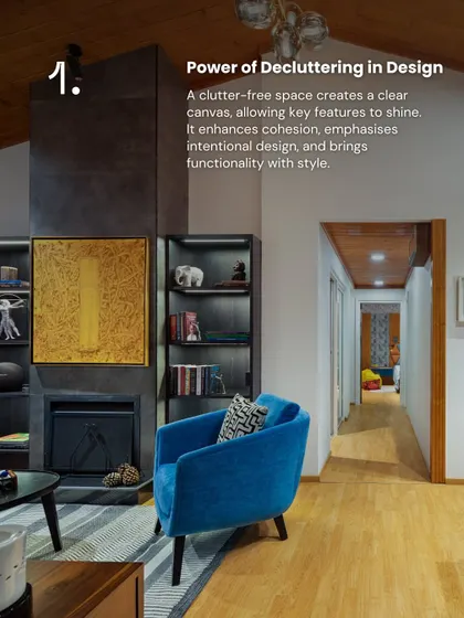A clutter-free space allows key features to shine. In this living area, the absence of clutter enhances the impact of the fireplace, the bold blue Ava chair, and the thoughtfully curated bookshelves, creating a room that feels intentional and stylish.