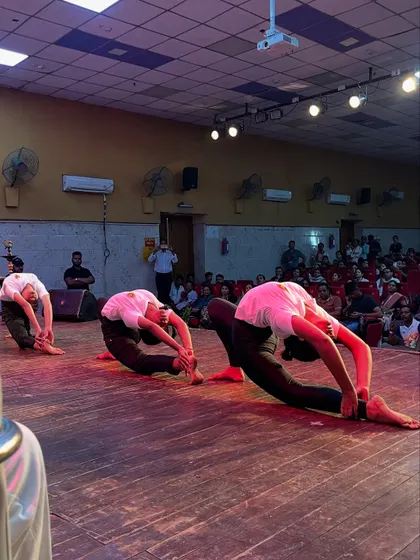 A synchronized deep forward bend performed by my students, showcasing incredible flexibility during the Yog Mahakumbh event.