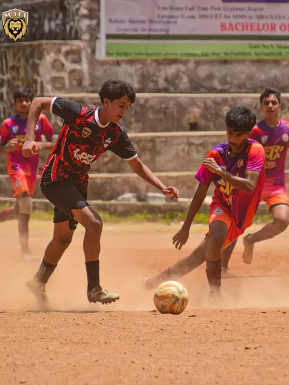 Another action shot from the dusty pitch, with our player focused on dribbling past the opposition.