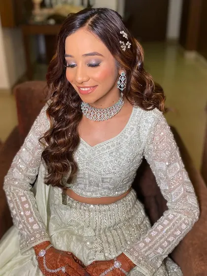 A soft, dreamy close-up of this glass skin look. The shimmering eyeshadow and glossy lips are the perfect finishing touches for a glamorous reception.