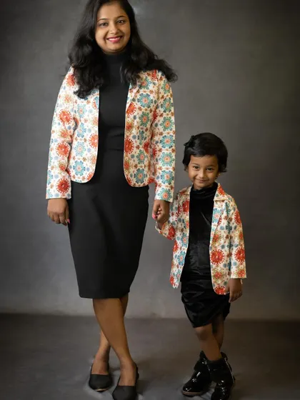 A full-length portrait of a mother and daughter in their stylish matching jackets. It’s a fun way to showcase their special bond and shared sense of style.