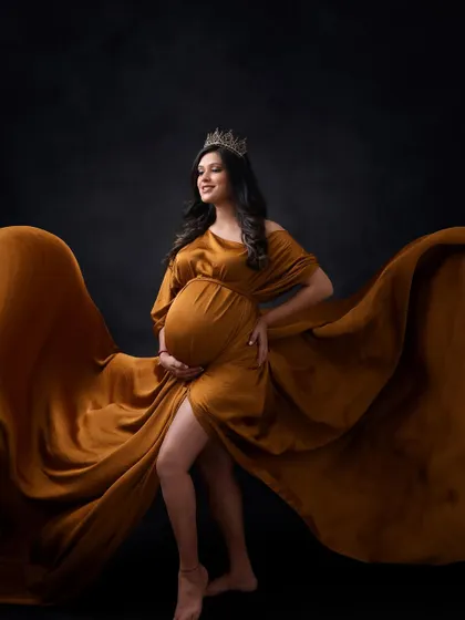 A true queen. With a crown and a magnificent flowing gown, this mom-to-be looks absolutely regal and powerful in this stunning maternity portrait.