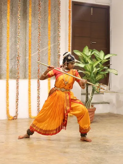 A young dancer performs a piece with a staff, showcasing a unique blend of dance and martial arts at our Platform Performance event.
