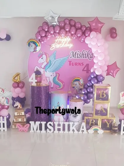 A winged unicorn theme in shades of purple and pink, complete with 'BABY' blocks and a custom backdrop.