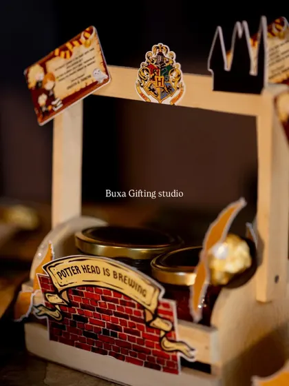 A close-up of a budget-friendly Harry Potter hamper, featuring two jars of treats and themed cutouts.