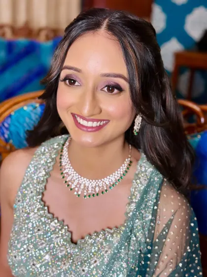 The lovely Ruthvika, all smiles for her reception. I created a soft purple-toned eye makeup look to match her stunning mint green lehenga.