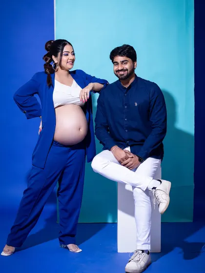 A relaxed and confident pose from our color-block series. This modern approach to maternity photography is perfect for couples with a bold sense of style.