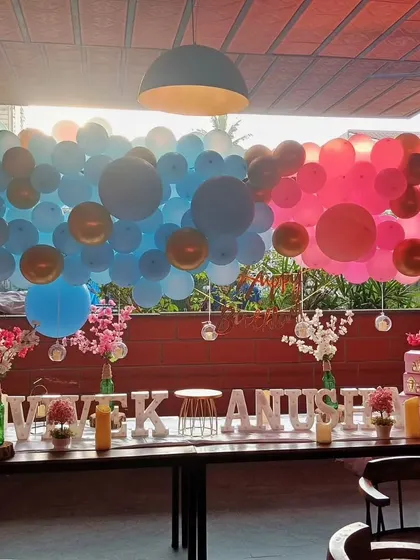 This impressive balloon wall is perfect for a gender reveal. One side is filled with shades of blue and the other with shades of pink, creating a dramatic and fun backdrop for the big announcement.