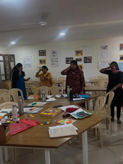 Teachers participating in a mindfulness exercise, a 'brain energizer' activity, during a professional development session at Cambridge School. I integrate these techniques to help manage classroom energy and promote focus.
