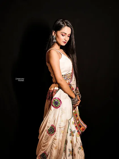 A side profile portrait capturing the quiet elegance of the Navratri look, with a focus on the drape of the lehenga and the model's serene posture.