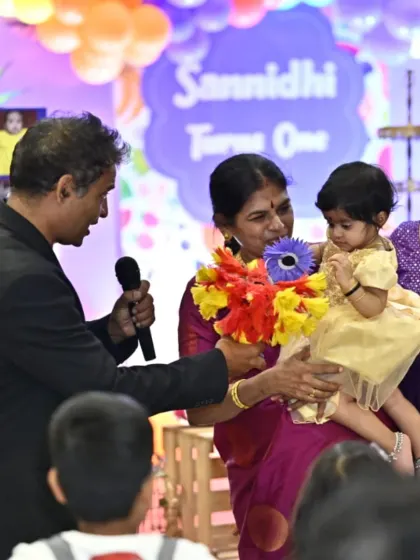 A special moment with the birthday girl on her first birthday. I use simple props like these fun, colorful flowers to interact even with the youngest toddlers.