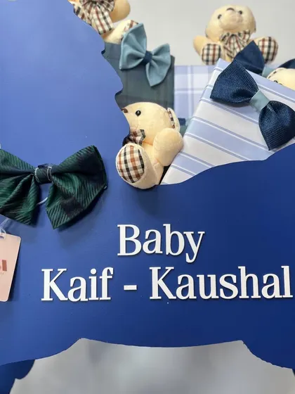 A close-up of the personalized name on the deep blue rocking horse, a statement piece designed to be both a gift and a nursery treasure.
