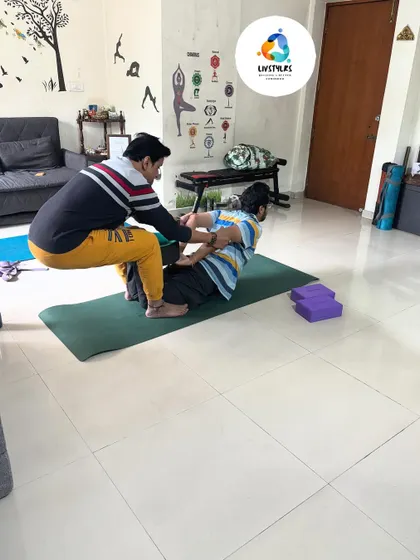I am providing an assist in Matsyasana (Fish Pose) to help a client achieve a deeper and safer backbend. This hands-on guidance is key to advancing one's yoga practice.
