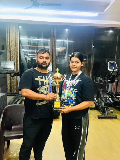 My junior lifter Yashika with her trophy after winning a gold medal and the strongwoman title at an inter-university competition. A proud moment for our team.
