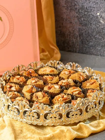 Another beautiful presentation of my gourmet baklava, served in an ornate silver-crowned dish. It's a luxurious treat that is sure to impress your guests this Eid.