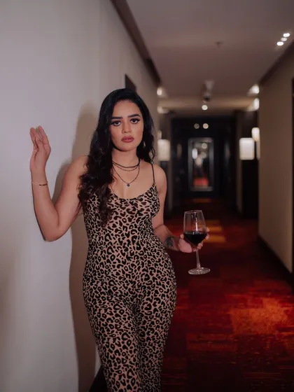 A duplicate of image 392, this sophisticated portrait of a model with a glass of red wine tells a story of luxury and style.