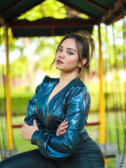 A more serious, confident pose in the blue bodysuit, showing versatility in mood.