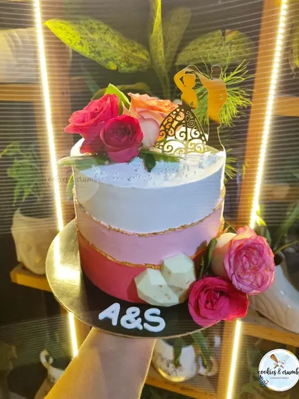 This ombre cake in shades of pink was for an intimate wedding reception. I used a couple silhouette topper and fresh roses to create a romantic design, and the flavor inside was my popular Mango Tango.